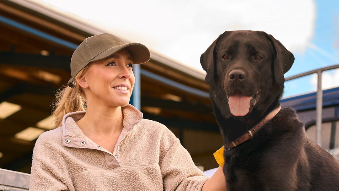 Dog owner with her black Labrador and a bag of INVIROX bully sticks